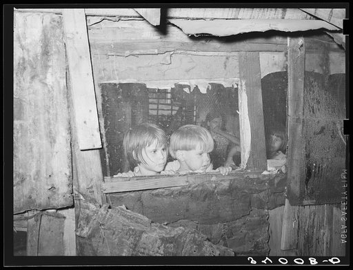 Children looking outside of window of shack home. Community camp, Oklahoma City, Oklahoma. See general caption no. 21
