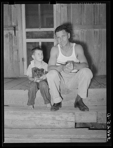 Oil field truck driver and his son sitting on front porch. Seminole, Oklahoma