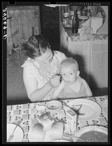 Wife of unemployed oil worker feeding her baby. Seminole, Oklahoma