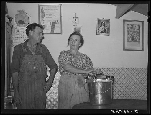 Mr. and Mrs. Schoenfeldt, FSA (Farm Security Administration) clients, in Sheridan County, Kansas, with pressure cooker of which she is very proud