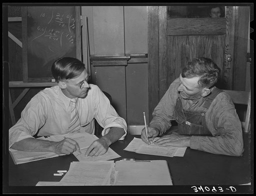 FSA (Farm Security Administration) supervisor conferring with client about farm plan. Sheridan County, Kansas