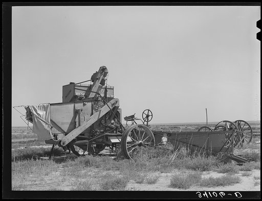 Old combine which has not been used for several years. Gray County, Kansas