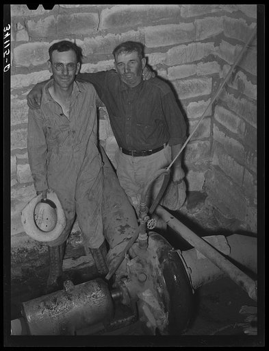 Untitled photo, possibly related to: Mr. Johnson and Mr. Wright, owners and cooperators in irrigation well on farm near Syracuse, Kansas. They are FSA (Farm Security Administration) clients