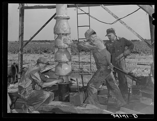 Getting ready to put in the pumping part of the water well for irrigation purposes on a farm near Garden City, Kansas
