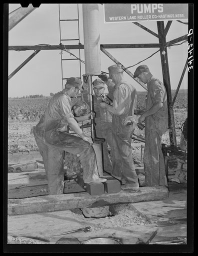 Getting ready to put in the pumping part of the water well for irrigation purposes on farm near Garden City, Kansas