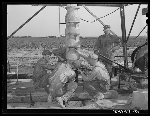 Untitled photo, possibly related to: Getting ready to put in the pumping part of the water well for irrigation purposes on farm near Garden City, Kansas