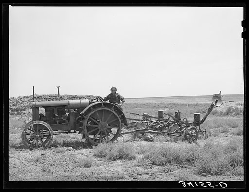 Mr. Bosley on his tractor and planter on the Bosley reorganization unit. Baca County, Colorado