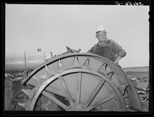 Mr. Bosley, sitting on his tractor. Bosley reorganization unit, Baca County, Colorado