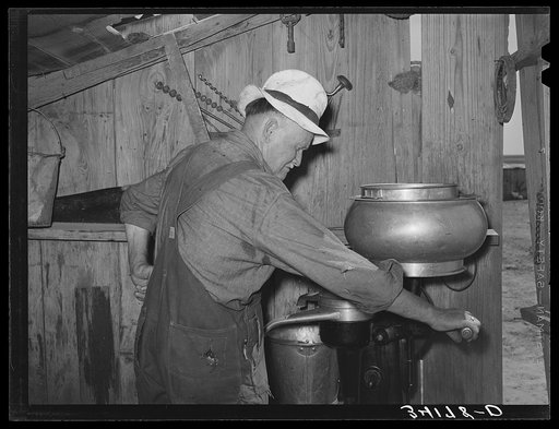 Mr. Bosley of Bosley reorganization unit, Baca County, Colorado, getting ready to start up the milk separator