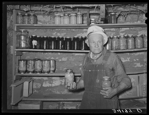 Mr. Bosley, of the Bosley reorganization unit in Baca County, Colorado, with canned fruits in his cellar