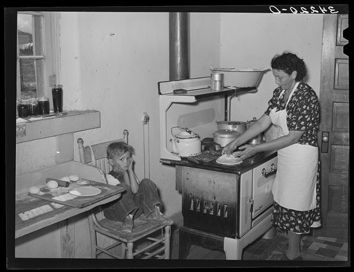 Kitchen scene in Spanish-American home near Taos, New Mexico, Taos County. Making tortillas