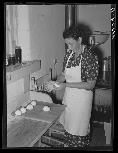 Shaping dough into balls before rolling out tortillas. Spanish-American home near Taos, New Mexico, Taos County