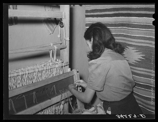 Spanish-American girl threading the loom at WPA (Works Progress Administration/Work Projects Administration) weaving project. Costilla, New Mexico