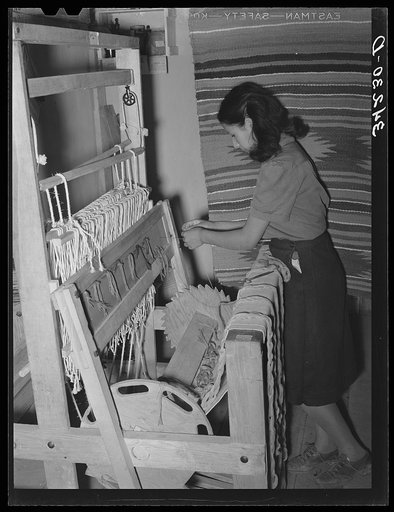 Spanish-American girl threading the loom at WPA (Works Progress Administration/Work Projects Administration) weaving project. Costilla, New Mexico