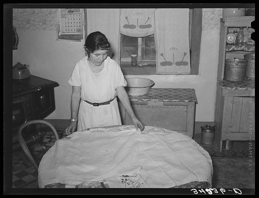 Untitled photo, possibly related to: Spanish-American woman covering dough so that shaped loaves will rise evenly. Near Taos, New Mexico