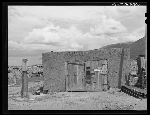Garage and old gasoline pump on Spanish-American farm near Questa, New Mexico