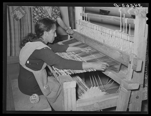 Running shuttle through warp in making rag rug at WPA (Works Progress Administration/Work Projects Administration) project at Costilla, New Mexico