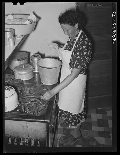 Untitled photo, possibly related to: Spanish-American woman removing baked bread from oven farm near Taos, New Mexico
