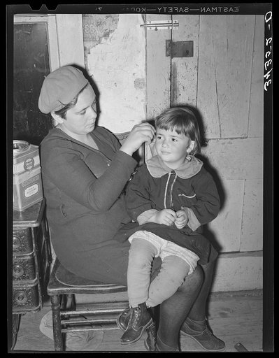 Wife of FSA (Farm Security Administration) client fixing her daughter's hair. Farm near Bradford, Vermont, Orange County