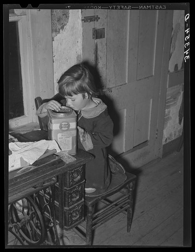 Untitled photo, possibly related to: Daughter of FSA (Farm Security Administration) client looking into candy jar. Farm near Bradford, Vermont
