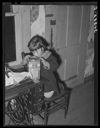 Daughter of FSA (Farm Security Administration) client looking into candy jar. Farm near Bradford, Vermont