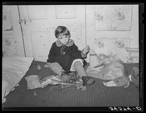Daughter of FSA (Farm Security Administration) client playing in her home in Orange County near Bradford, Vermont