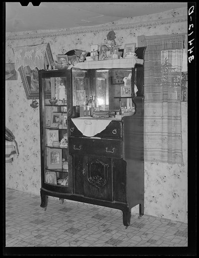 Sideboard weighed down with photographs in Spanish-American home in Taos County, New Mexico