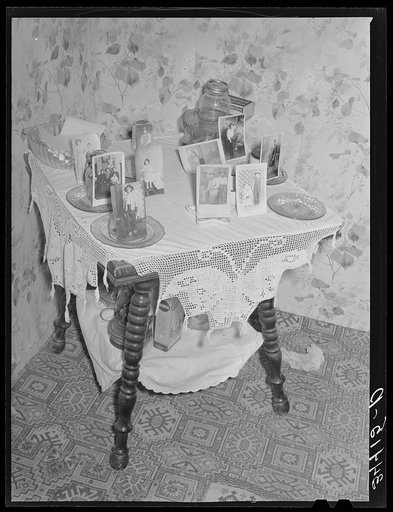 Photographs on table in Spanish-American farm home in Taos County, New Mexico