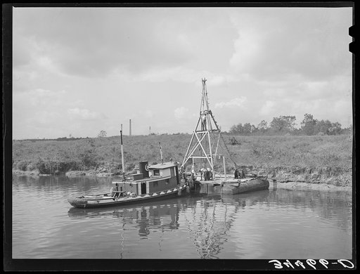 Oil drillers preparing to take a core to determine nature of sand in the basin of the port of Houston, Texas