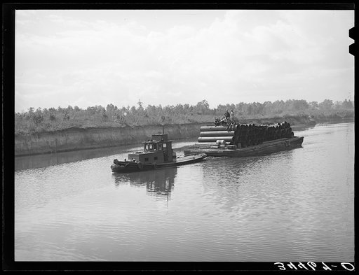 Barge loaded with pipe. Port of Houston, Texas