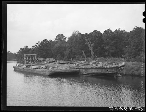 Hulls rotting along the bayou which joins the port of Houston, Texas