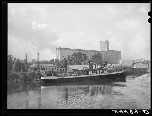Flour mill and tug. Port of Houston, Texas