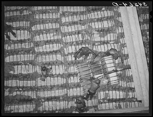 Untitled photo, possibly related to: Storing bales of cotton into hold of freighter for export. Notice the different levels. Port of Houston, Texas