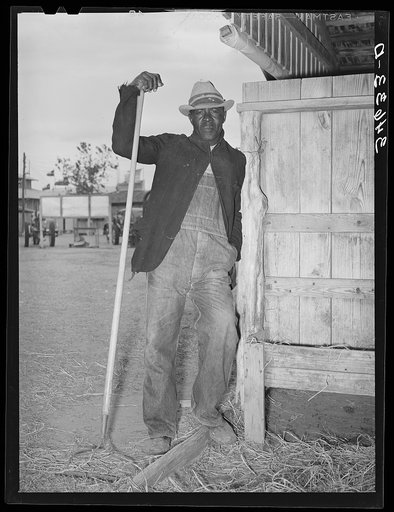 Worker in the show barns at the Gonzales County Fair. Gonzales, Texas