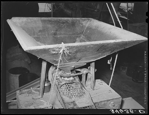 Hopper into which corn is poured for grinding feed mill. Taylor, Texas