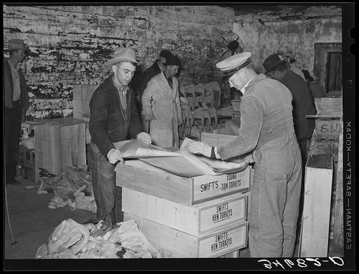 Lining boxes with paper before packing with turkeys. Cold storage plant, Brownwood, Texas