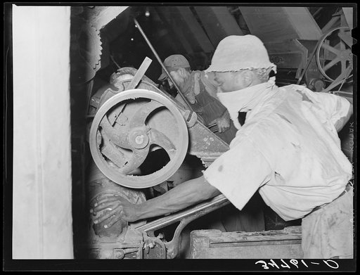 Negro working on machine in cotton seed oil mill. McLennan County, Texas