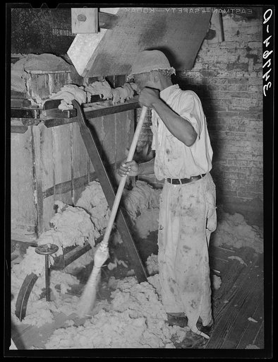 Untitled photo, possibly related to: Negro working levers for baling machine in cotton seed oil mill. McLennan County, Texas