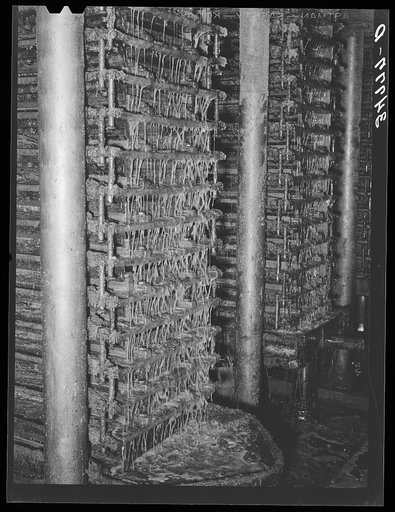 Untitled photo, possibly related to: Cotton seed oil running from hydraulic presses. Cotton seed oil mill. McLennan County, Texas