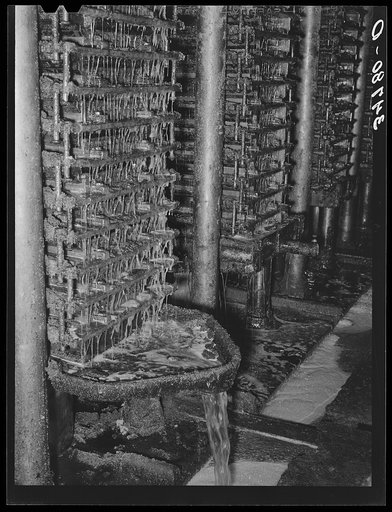 Cotton seed oil running from hydraulic presses. Cotton seed oil mill. McLennan County, Texas