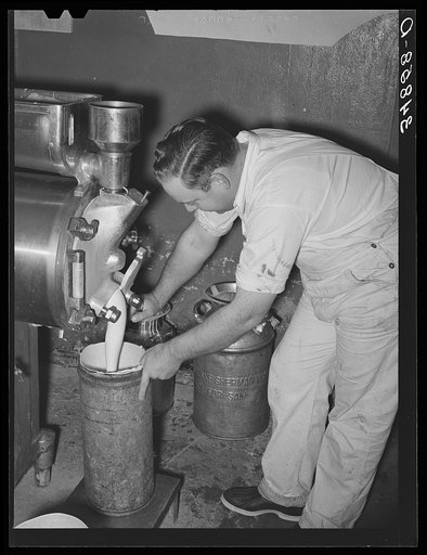 Filling can with ice cream mix. Creamery, San Angelo, Texas. Later it will be placed in freezer
