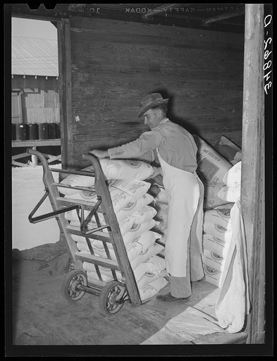 Unloading carload of flour. Wholesale grocery, San Angelo, Texas