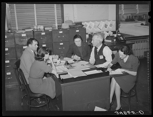 Meeting of county FSA (Farm Security Administration) supervisors and assistant to determine program for the week. Limited mileage allowance requires careful planning in these large counties so that clients can be visited. San Angelo, Texas