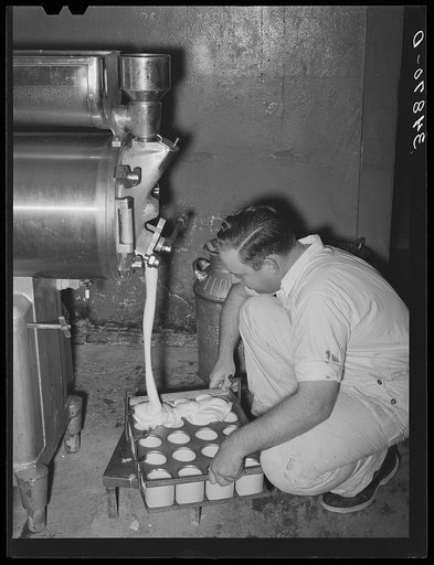 Filling cartons with ice cream mix. Creamery, San Angelo, Texas