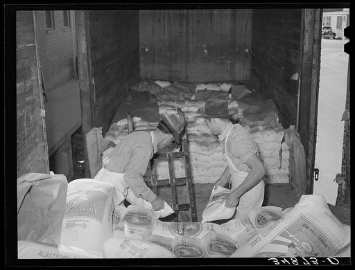 Unloading carload of flour. Wholesale grocery, San Angelo, Texas