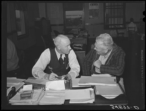 County FSA (Farm Security Administration) supervisor talking with client. San Angelo, Texas