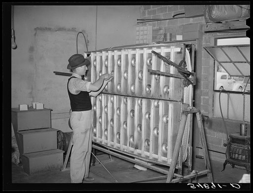 Crimping an innerspring mattress so the tufts will be more easily put in. Mattress factory. San Angelo, Texas