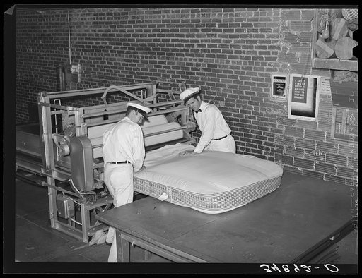 Filling mattress case with cotton linters. Mattress factory. San Angelo, Texas