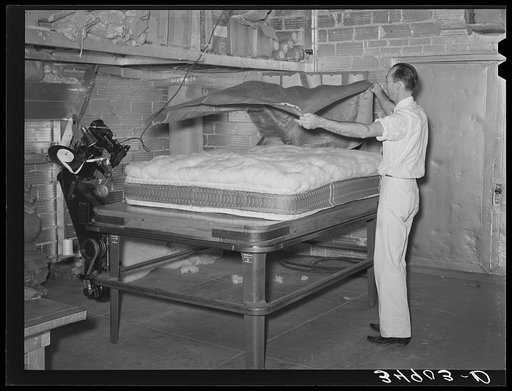 Laying cover over mattress. Mattress factory. San Angelo, Texas