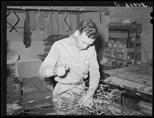 Tying springs which will go into innersprings mattress. Mattress factory. San Angelo, Texas